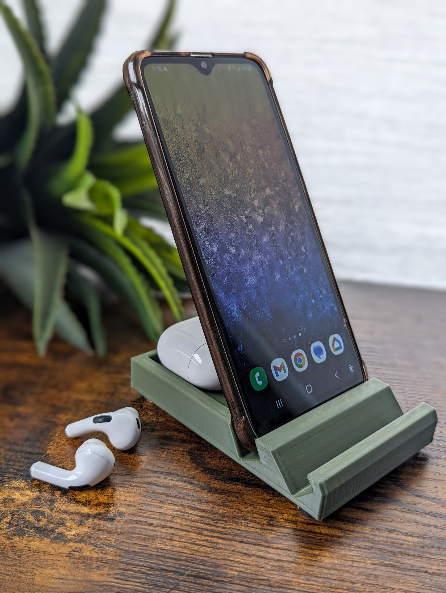 Minimalist phone holder with two display vantage angles. Back tray ideal for storing air pods or earbuds. Comes in a variety of colors and may be customized for the dimensions of any device.