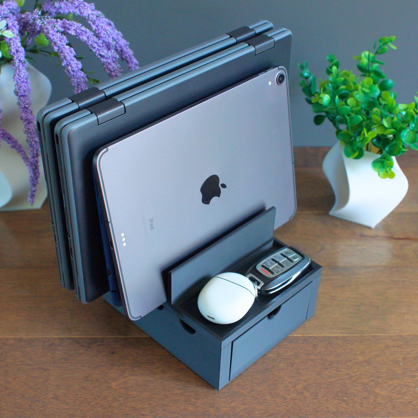 Multiple mobile device Family charging station with 4 slots and front tray, 2 thin laptops slots and 2 slots for  tablets, phones etc. We designed our docking stations with reinforced back and rubber footing to ensure the devices are held securely.