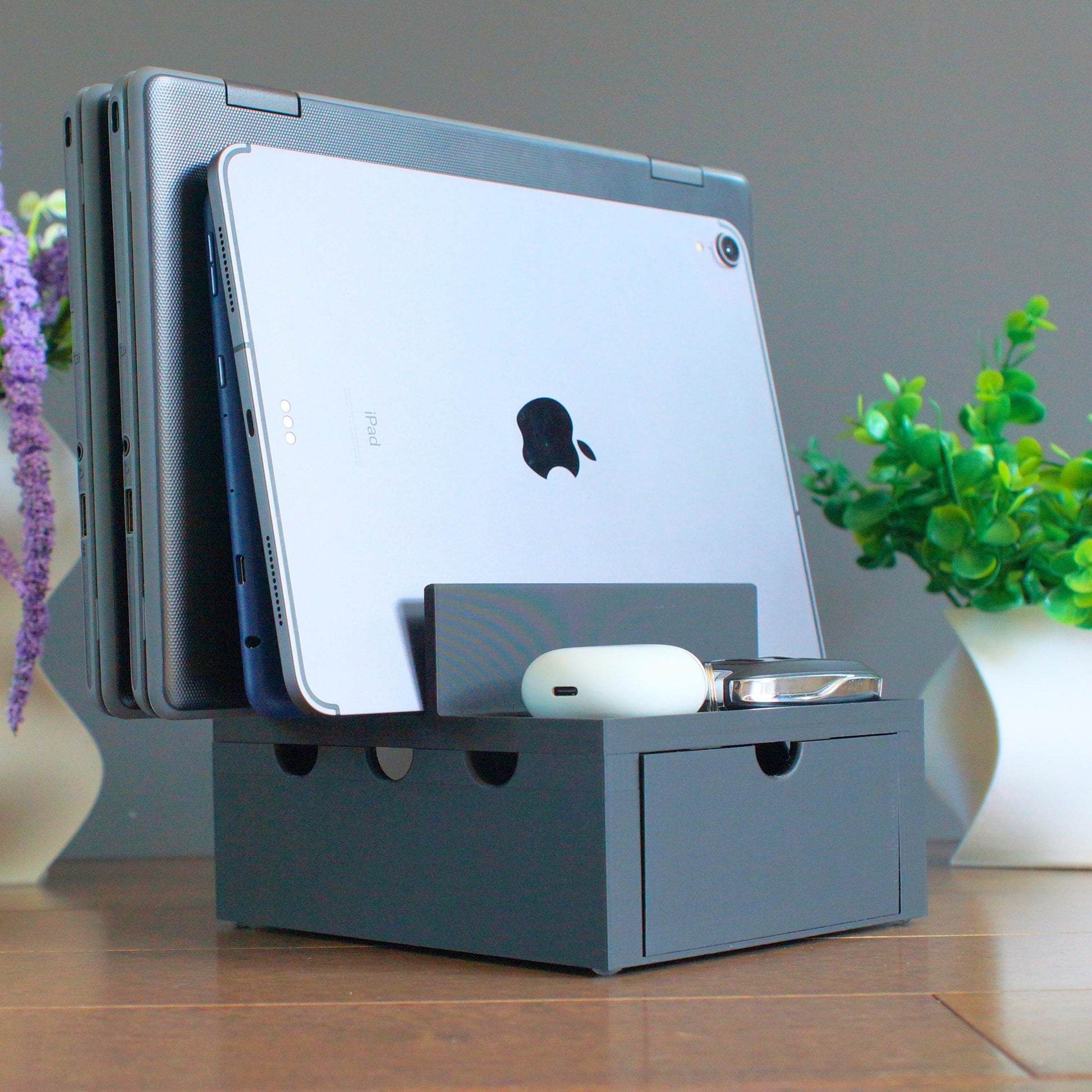 Multiple mobile device Family charging station with 4 slots and front tray, 2 thin laptops slots and 2 slots for  tablets, phones etc. We designed our docking stations with reinforced back and rubber footing to ensure the devices are held securely.