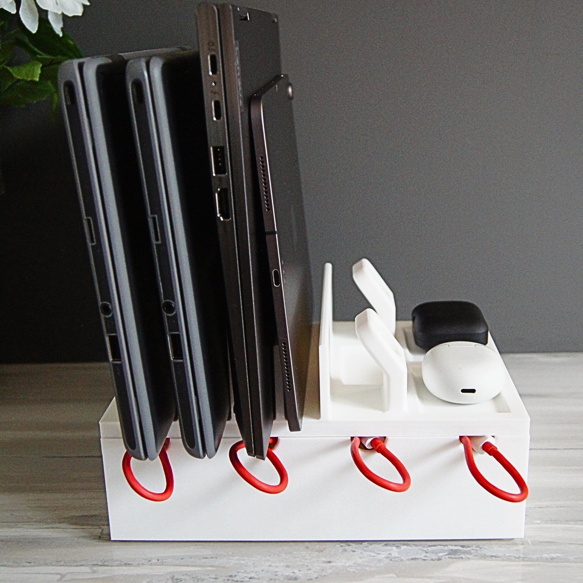 Multiple mobile device Family charging station with 4 slots, 2 large laptop slots and 2 slots for thin laptops, tablets, phones, 2 apple watches etc.  Designed with reinforced back and rubber footing to ensure the devices are held securely.