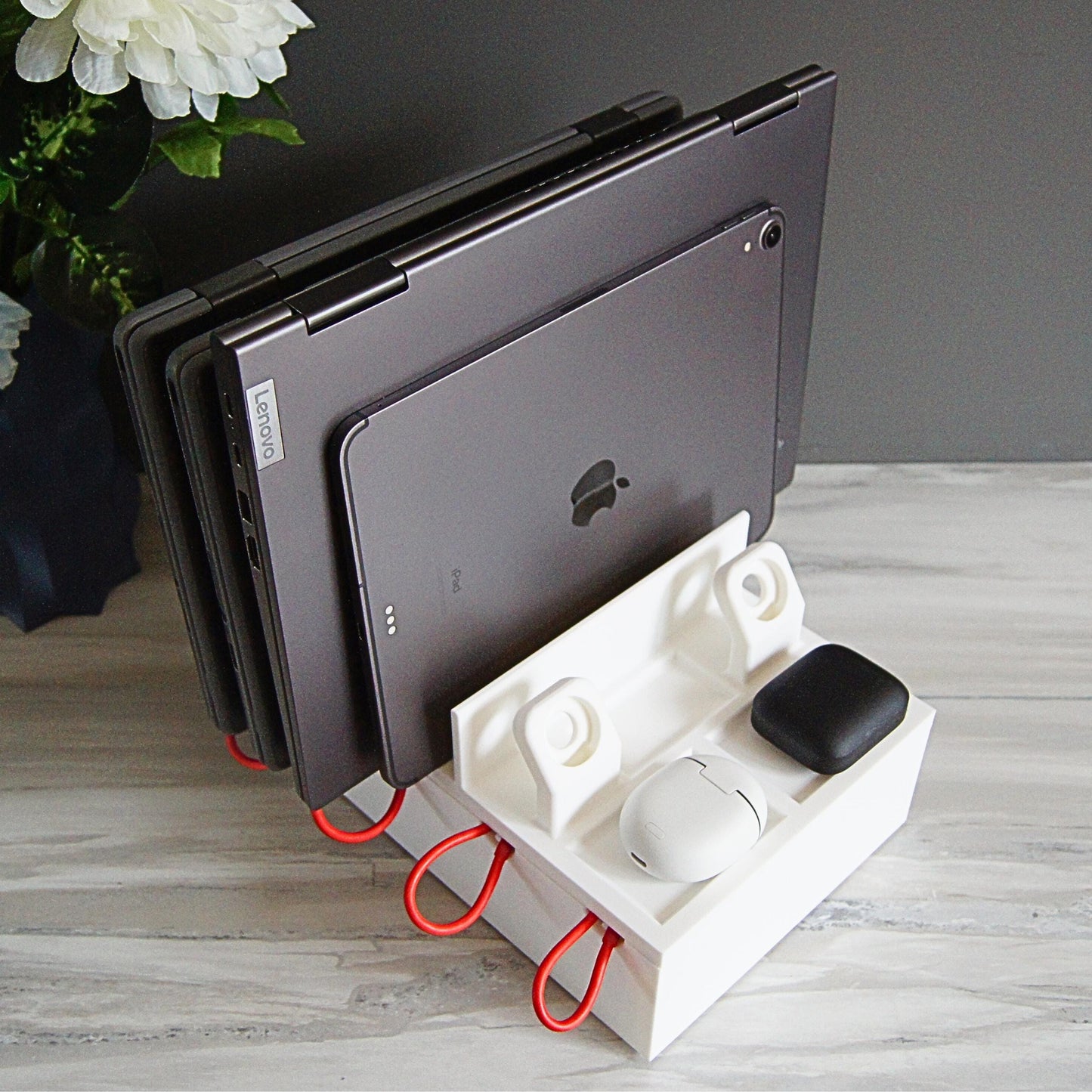 Multiple mobile device Family charging station with 4 slots, 2 large laptop slots and 2 slots for thin laptops, tablets, phones, 2 apple watches etc.  Designed with reinforced back and rubber footing to ensure the devices are held securely.