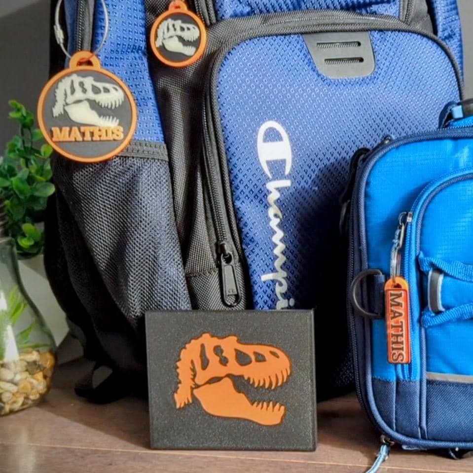 Glow in the dark T-Rex name tag set. Back to school set of backpack bag tag, lunchbox name tag and a keychain / keyring charm set. Comes with a complimentary gift box.