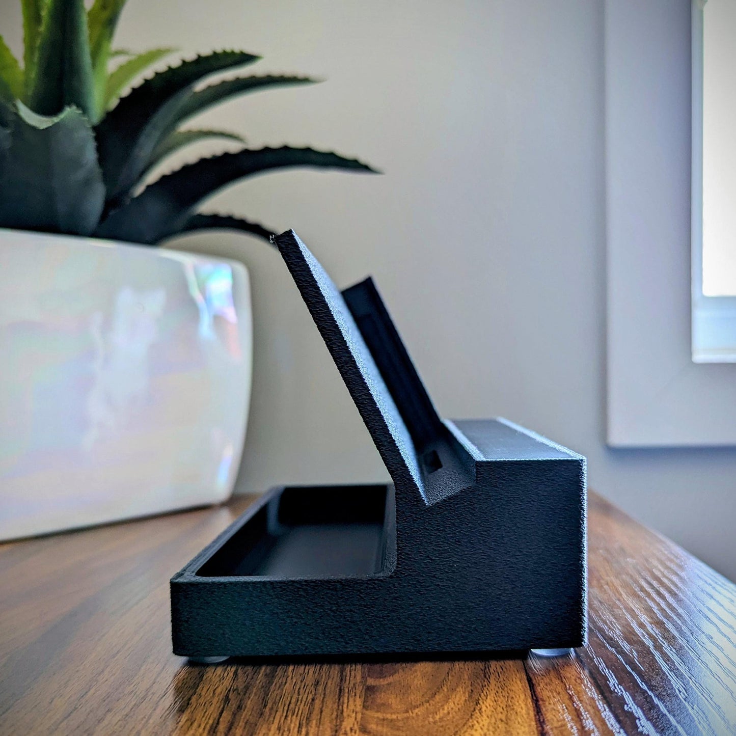 Phone stand with acoustic booster ideal for movie viewing. Back tray ideal for storing air pods or earbuds. Comes in a variety of colors and compatible with nearly all phones.