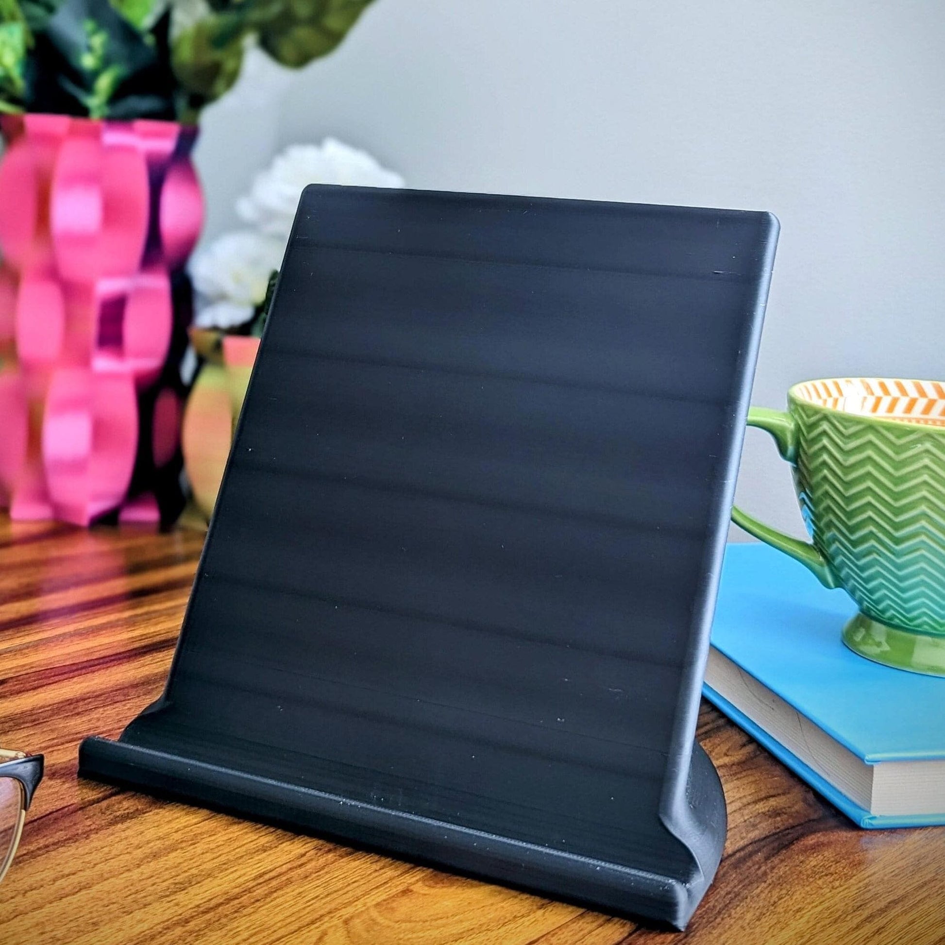 Minimalist tablet stand ideal for all tablets (Ipad, Samsung, Acer, etc.). Alternatively it could be a great addition to your kitchen for displaying cook books.